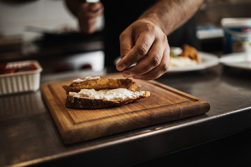 Professional chef working in restaurant kitchen and making delicious traditional food.