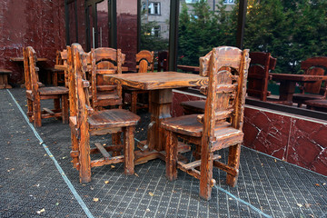 massive tables and chairs on the veranda of a street cafe