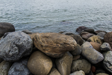 big stones on a calmed ocean shore