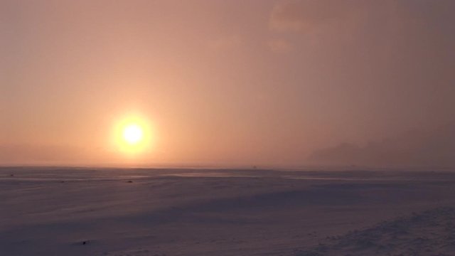 Wide, sunset over tundra landscape