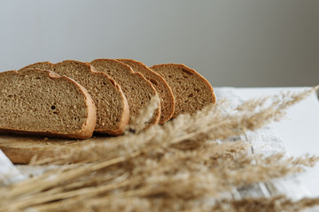 Sliced bread on a board on a white tablecloth