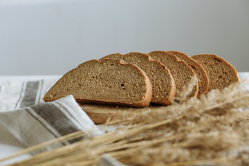Sliced bread on a board on a white tablecloth
