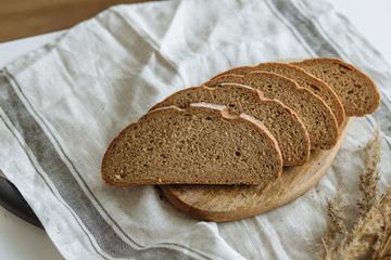 Sliced bread on a board on a white tablecloth