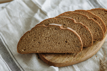 Sliced bread on a board on a white tablecloth