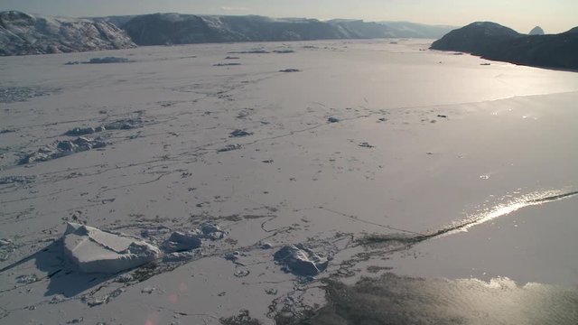 Wide, sun shines over frozen landscape