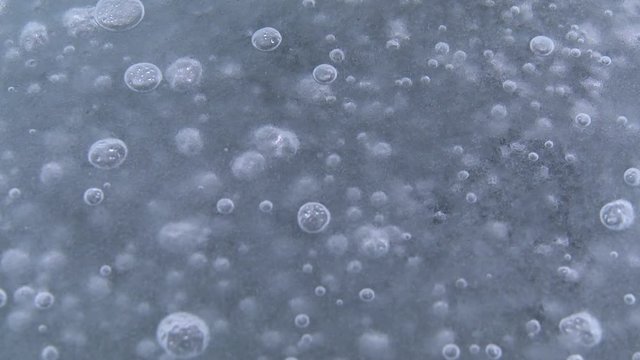 Tilt down, frozen bubbles in Greenland