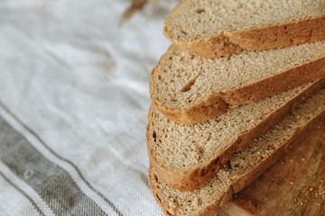 Sliced bread on a board on a white tablecloth