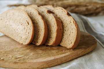 Sliced bread on a board on a white tablecloth