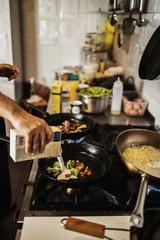 Professional chef working in restaurant kitchen and making delicious traditional food.
