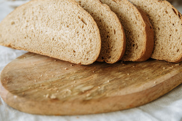 Sliced bread on a board on a white tablecloth