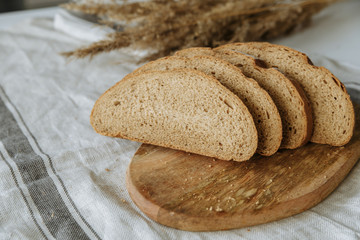 Sliced bread on a board on a white tablecloth