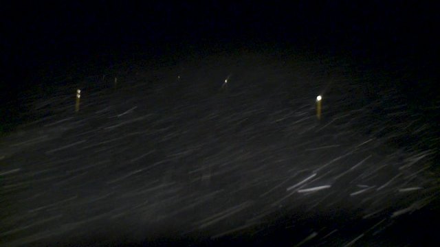 Driving through snowstorm at night, point of view