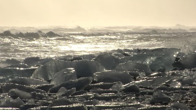 Wide, sunset over glacial ice on Iceland beach