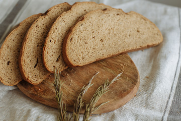 Sliced bread on a board on a white tablecloth