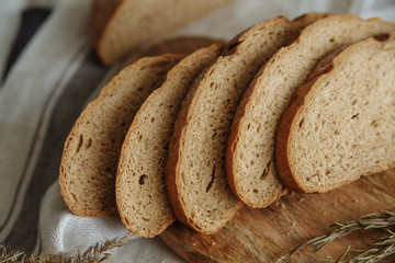 Sliced bread on a board on a white tablecloth