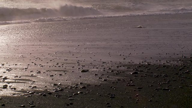 Close up, waves crash on Iceland beach