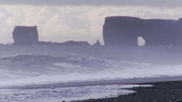 Coastal rock formations on Iceland beach, wide