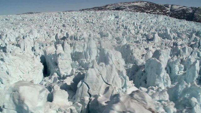Helicopter flies over Store Glacier in Greenland, aerial