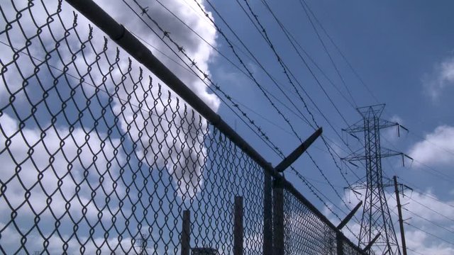 Smoke rises from factory, low angle