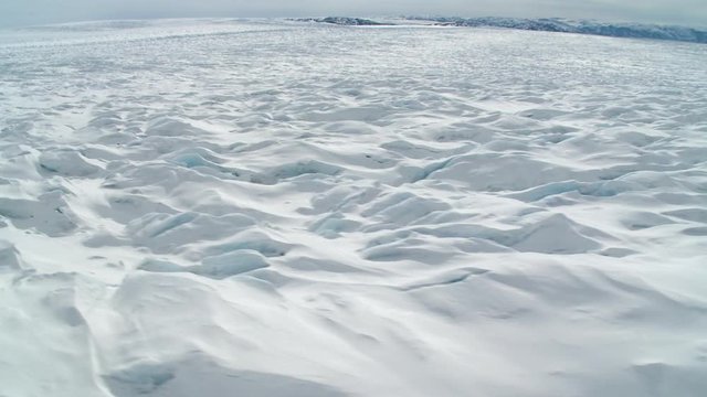 Point of view, helicopter flies over glacier