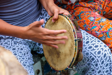 Woman's hands playing tambourine during capoeira performance from brazil - obrazy, fototapety, plakaty