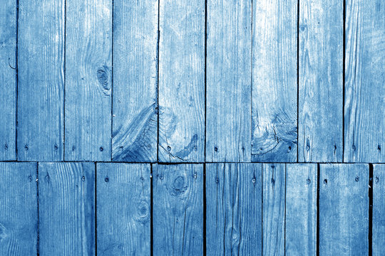 Old grungy wooden planks background in navy blue tone.