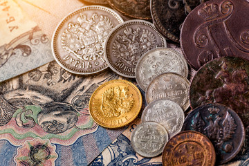 Gold and silver coins of the Russian Empire19 - 20 century in the background kopyur.Five rubles Nicholas II.Concept Russian antiques.Antikvariat.