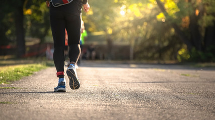 Back of a male runner in motion.