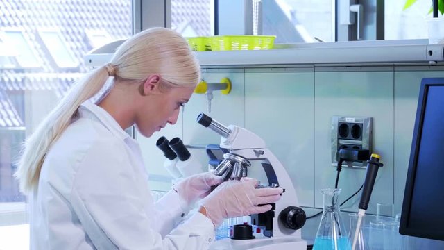 Female scientist working in modern lab. Doctor making microbiology research. Biotechnology, chemistry, bacteriology, virology, dna and health care concept.