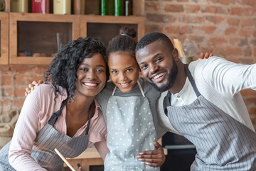 Close sweet family taking selfie at kitchen