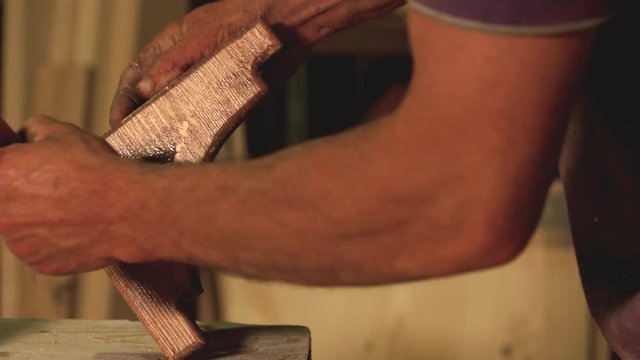 Carpenter covering piece of wood with a lacquer. Carpentry furniture woodworking production.