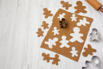 Homemade raw dough for making Christmas cookies on a white wooden background, low angle view. Copy space.