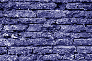 Old grungy brick wall texture in blue tone.