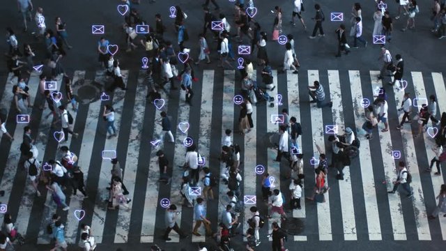 High Angle Shot of a Crowded Pedestrian Crossing in Big City. Augmented Reality of Transparent Social Media Signs, Symbols, Location Tracking and Emojis that are Attached to People. Technology Concept