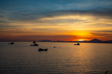 Fishing boats on sea in sunset lights in Sanya, Hainan, China