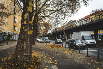 Street and road with cars and train in Berlin in autumn. Street in autumn in Berlin. Autumn cityscape in Berlin. travel and tourism in Berlin concept.