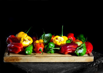 Colorful chili peppers on a black background, this species is sweet in taste, very common in South America.