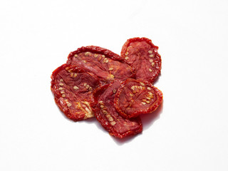 Sun Dried tomatoes in the sunshine on white