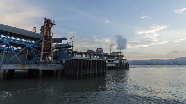 Timelapse Penang Port at Butterworth on the mainland (Sultan Abdul Halim Ferry Terminal). Carry passengers and cars. Shoot during sunset hour.