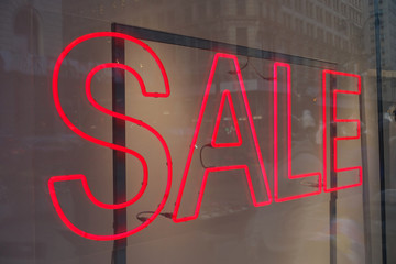 Red Neon Sale Sign in a Store Window