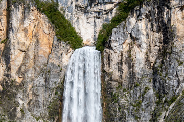 Fototapeta na wymiar Boka Waterfall ( Slap Boka ) is one of the highest waterfalls (139 meters) in the western part of Slovenia, near the Soča River. It has two stages of 106 meters and 33 meters high.