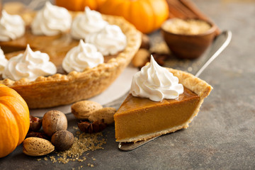 Traditional pumpkin pie topped with whipped cream