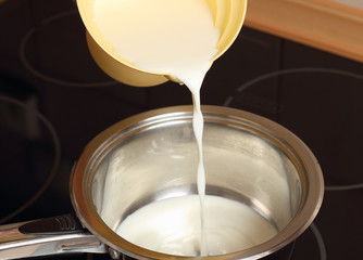 A chef pouring milk. Making Chocolate Cream. Series.