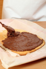 Spreading Chocolate Cream on Cake Base. Making Hungarian Cake.
