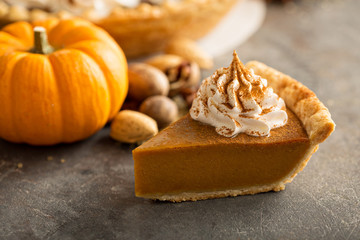 Traditional pumpkin pie topped with whipped cream - obrazy, fototapety, plakaty