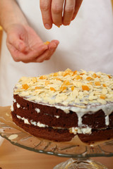 Spreading Sliced Almonds and Candied Orange Peel. Making Chocolate Layer Cake. Series.