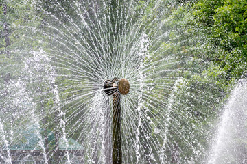 Detail of a rotating fountain spraying water at 360 degrees