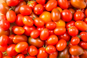Red tomatoes background. Top view. Fresh organic tomatoes as background, closeup. Group of fresh tomatoes
