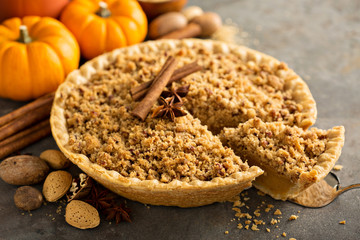 Traditional fall seasonal dessert, pumpkin pie with streusel crumb topping