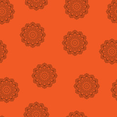 Seamless pattern. Brown mandala on an orange background. Vector modern texture